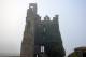 A medieval tower house at Kells Priory on a misty morning